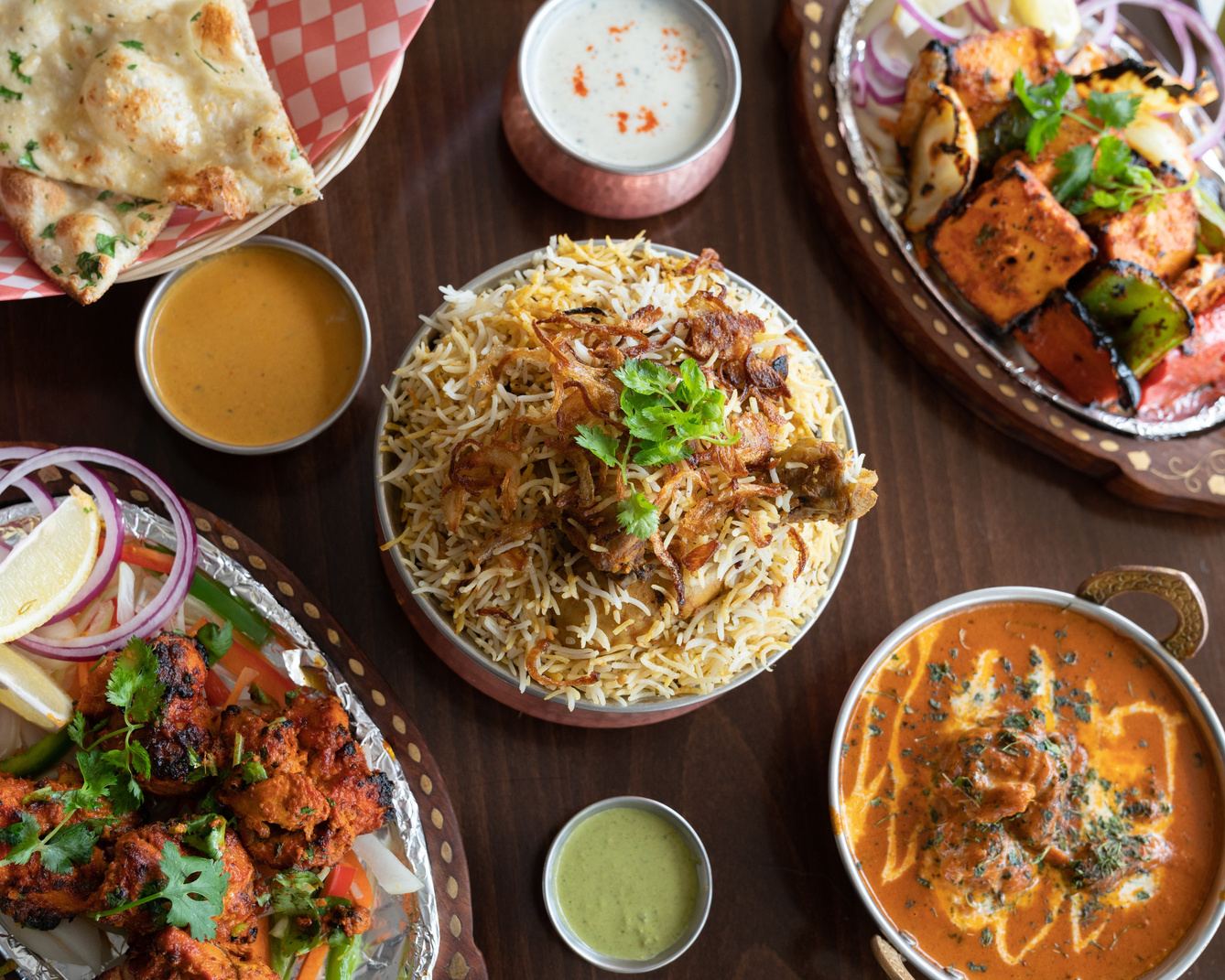Biryani, karahi, tikka and naan on a table